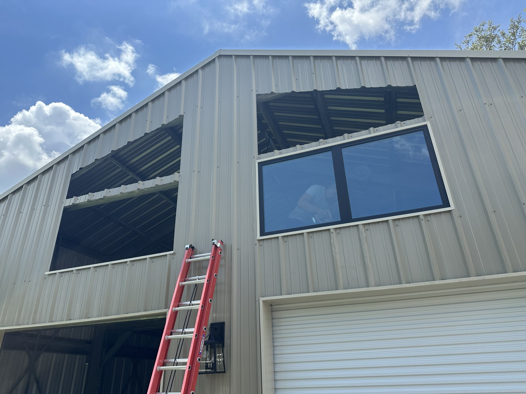 Before: mid-installation, one window set into a metal commercial building