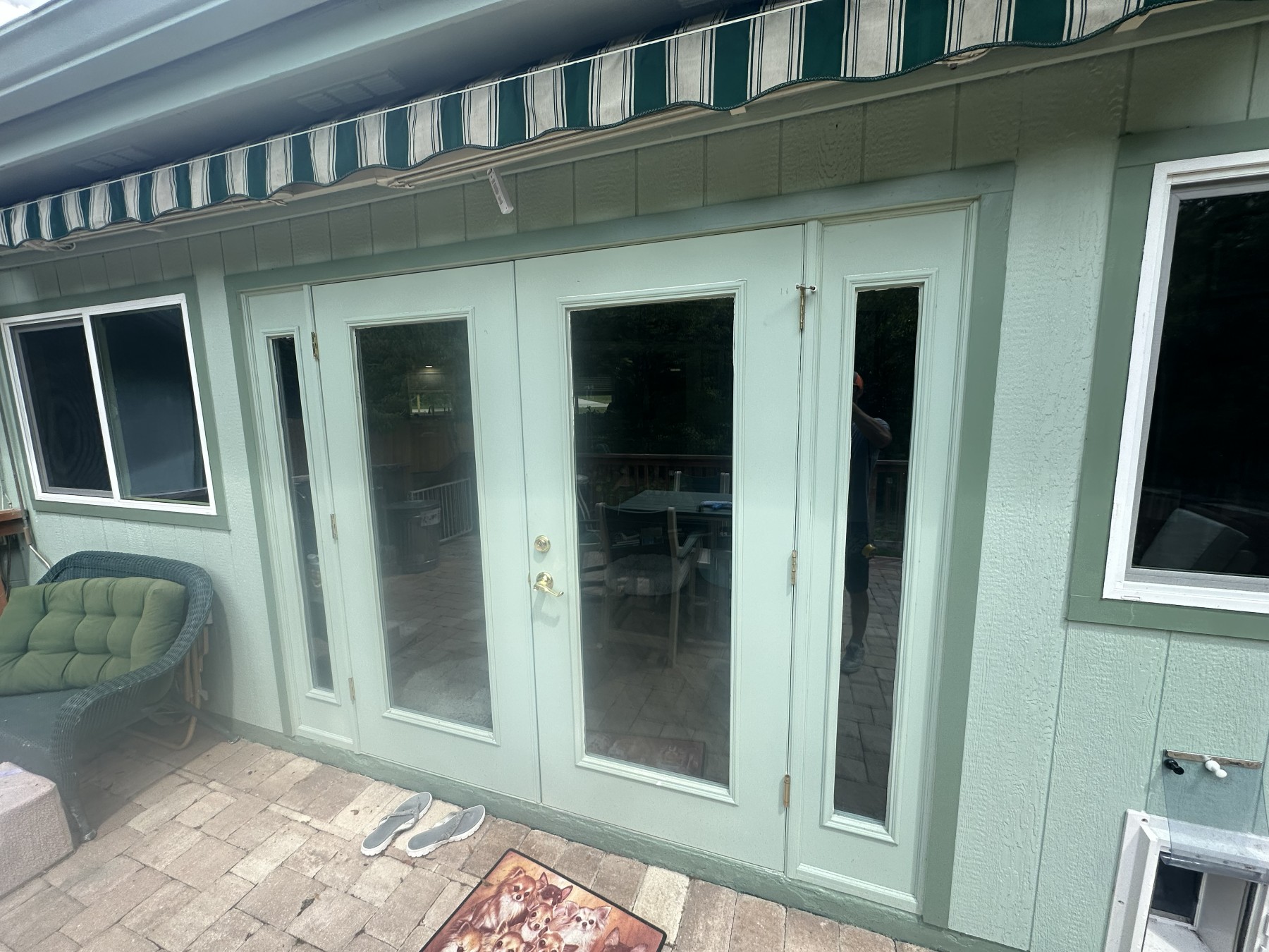 Before: original painted wood French doors on a patio