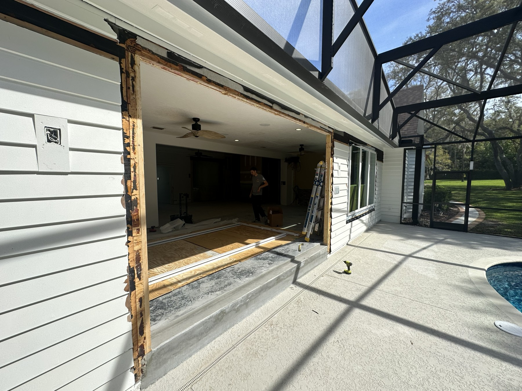 Before: rough opening with old sliding door removed, framing exposed