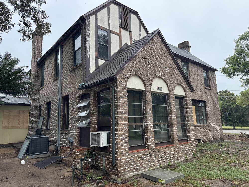 Before: original windows on a brick Tudor-style home